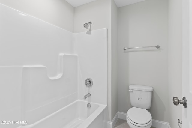 bathroom with shower / bathtub combination and toilet