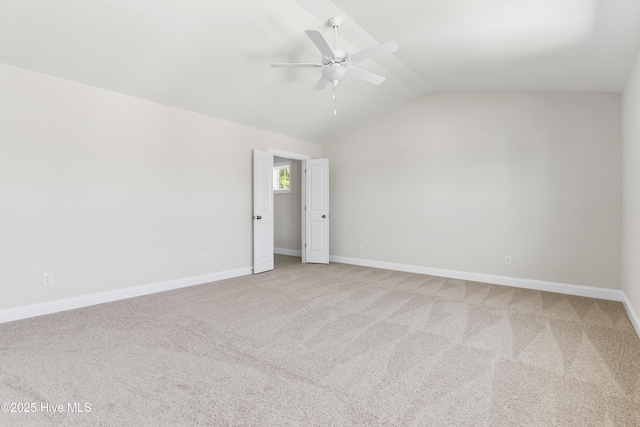 carpeted empty room with lofted ceiling and ceiling fan