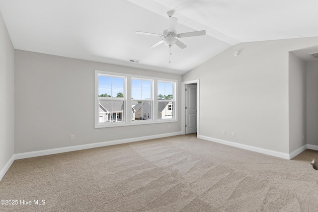 spare room featuring ceiling fan, lofted ceiling, and carpet