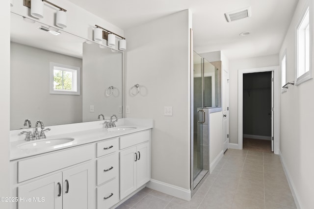 bathroom with vanity, an enclosed shower, and tile patterned floors