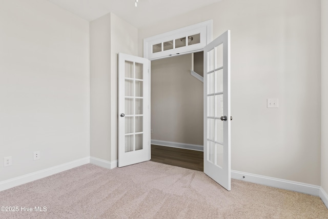 carpeted empty room with french doors