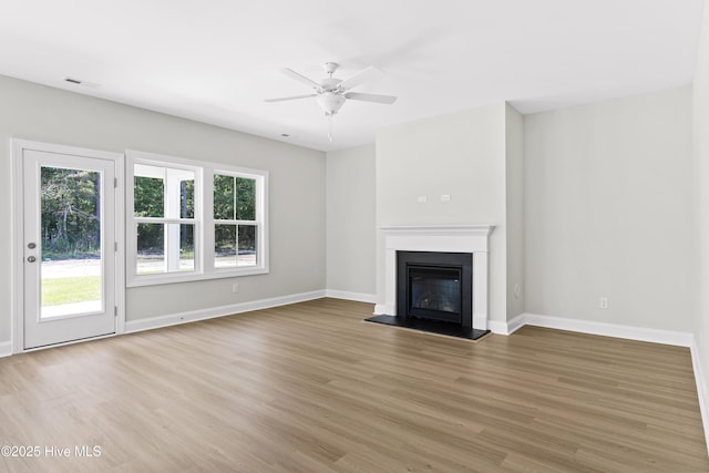 unfurnished living room featuring ceiling fan and light hardwood / wood-style flooring