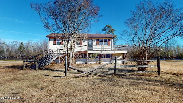 view of front of property with a wooden deck and a front yard