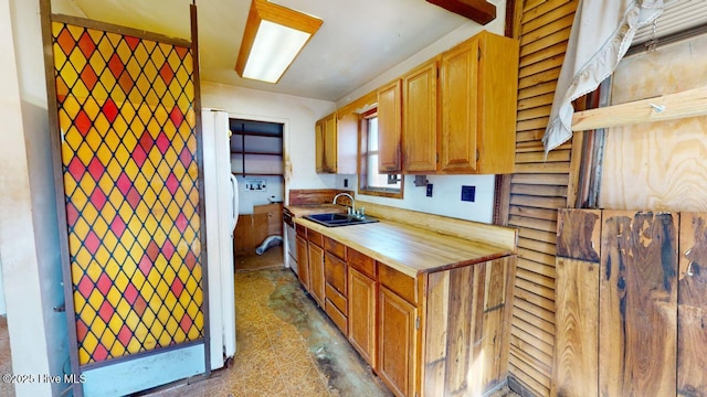 kitchen featuring dishwasher, white fridge, and sink