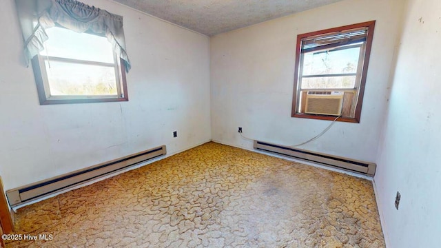 unfurnished room with cooling unit, a baseboard radiator, and a textured ceiling