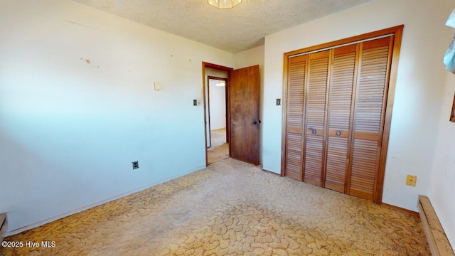 unfurnished bedroom with a closet and a textured ceiling