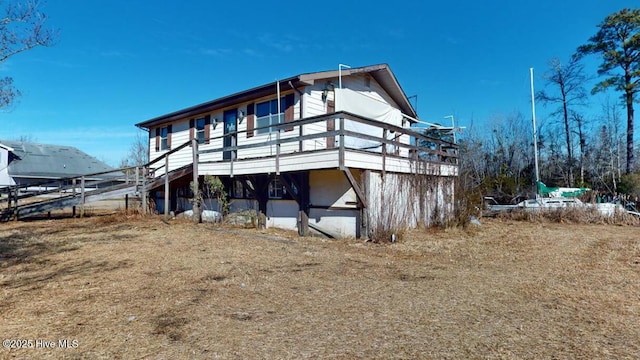 back of house featuring a yard and a deck