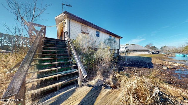 back of property featuring a water view