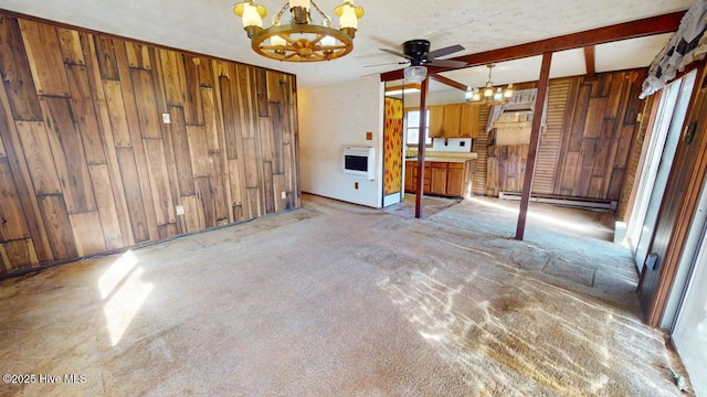 unfurnished living room with baseboard heating, heating unit, a textured ceiling, light carpet, and wood walls