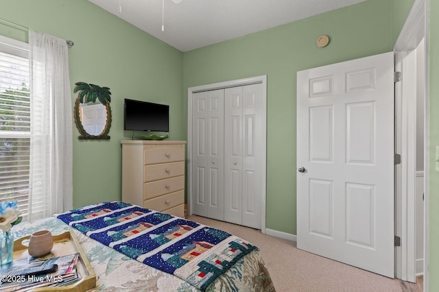 bedroom featuring carpet flooring and a closet