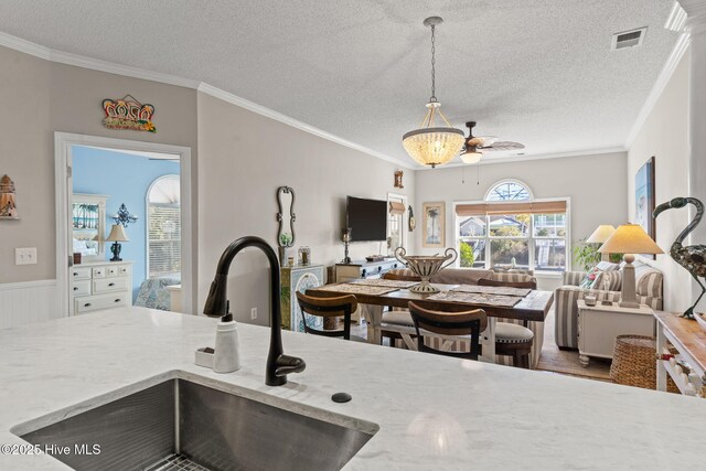 kitchen featuring white cabinetry, sink, stainless steel appliances, and a kitchen bar