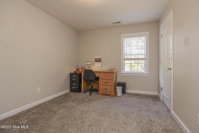 carpeted office featuring visible vents and baseboards