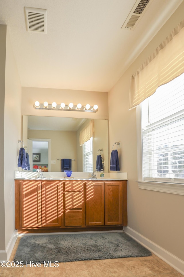 bathroom with tile patterned flooring, visible vents, vanity, and baseboards