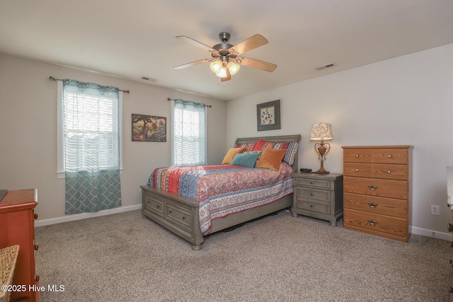 bedroom with baseboards, visible vents, ceiling fan, and light colored carpet