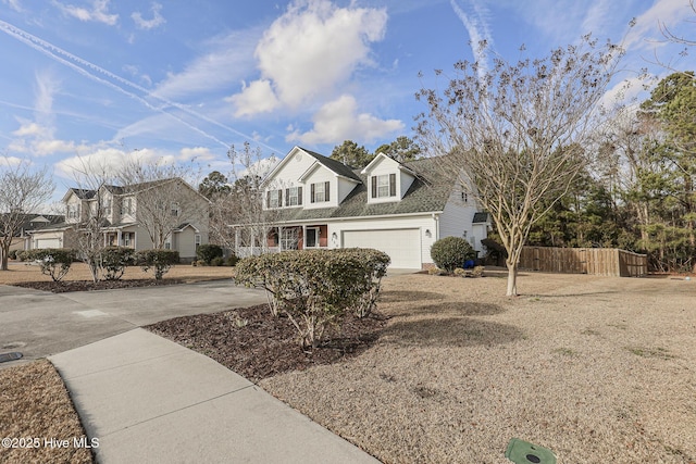 cape cod home featuring driveway, fence, and a residential view