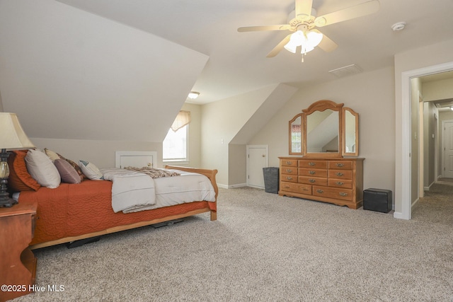 bedroom featuring light carpet, baseboards, vaulted ceiling, and a ceiling fan