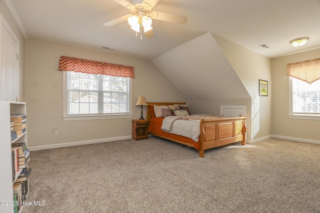 carpeted bedroom featuring lofted ceiling, visible vents, and baseboards