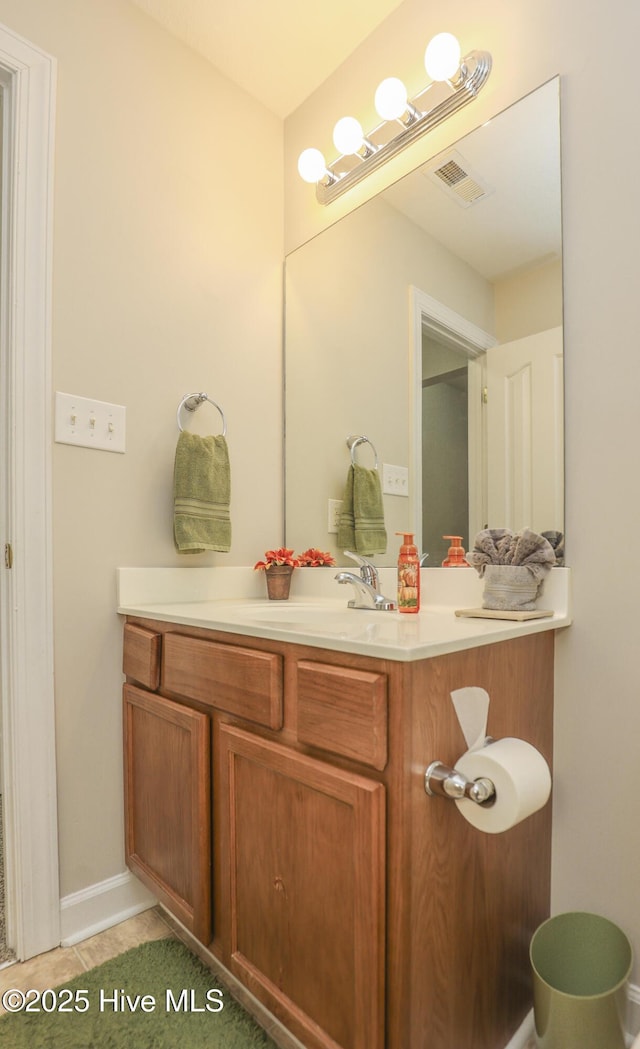 bathroom featuring visible vents, vanity, and baseboards