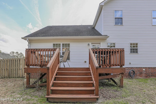 back of house with a shingled roof, stairs, fence, and a wooden deck