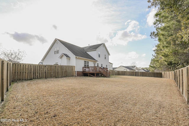 back of house featuring a deck and a fenced backyard