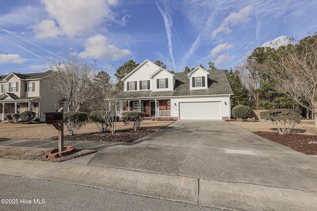 view of front of house with a shingled roof, covered porch, an attached garage, and concrete driveway