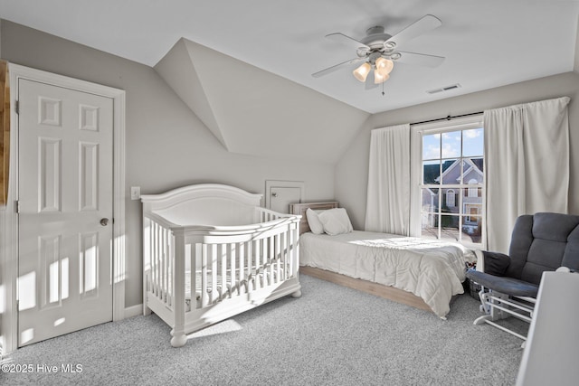 carpeted bedroom with ceiling fan and lofted ceiling