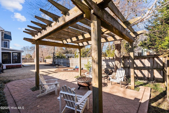 view of patio / terrace featuring a sunroom, a pergola, and a fire pit