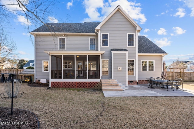 rear view of property with a patio, a yard, and a sunroom