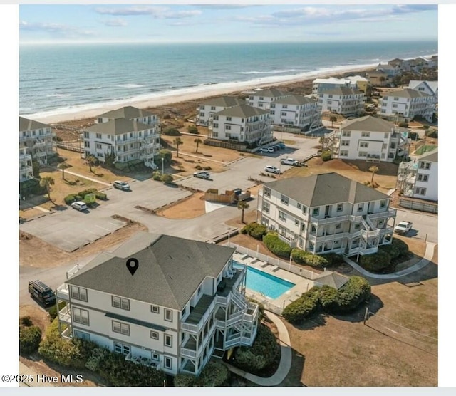 drone / aerial view featuring a water view and a beach view