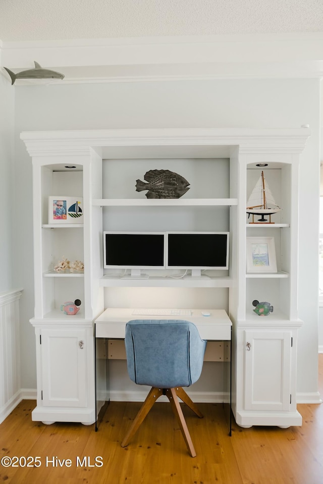 office area featuring built in desk and light wood-type flooring