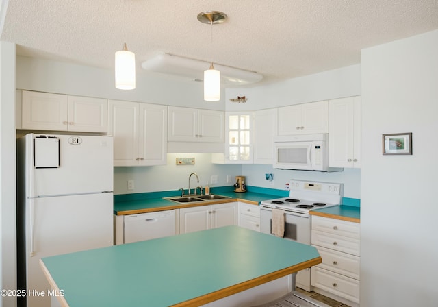 kitchen featuring white cabinetry, sink, white appliances, and pendant lighting