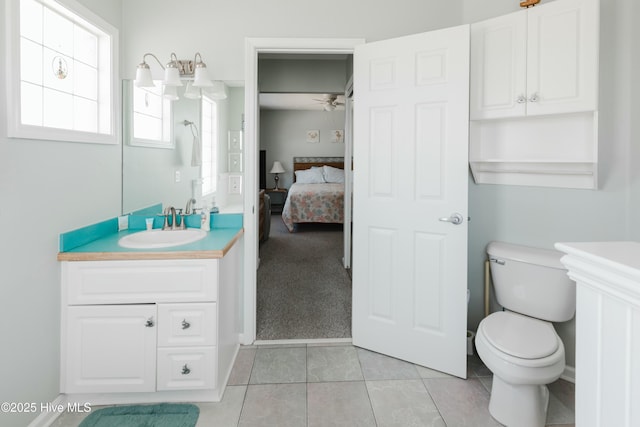 bathroom with vanity, ceiling fan, tile patterned floors, and toilet