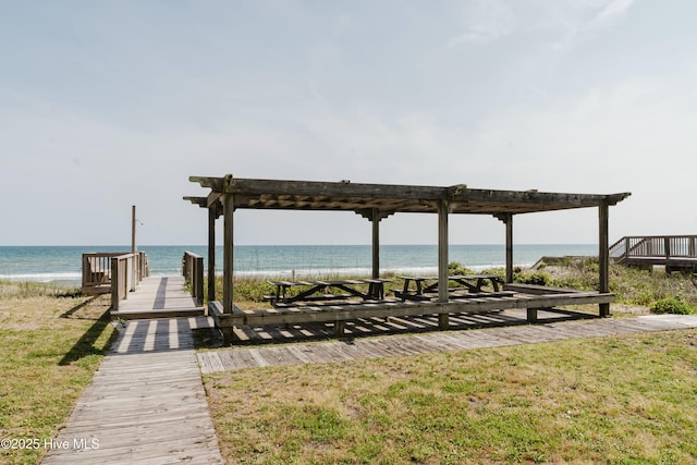 view of community with a water view and a beach view