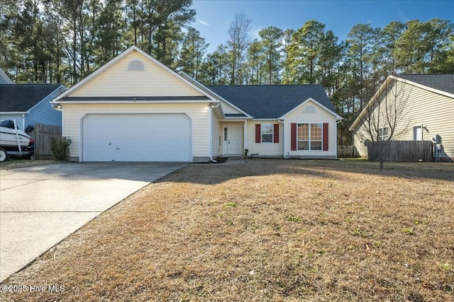 ranch-style house with a garage and a front yard