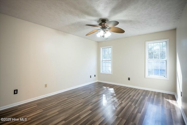 empty room with dark wood-type flooring, ceiling fan, and a textured ceiling