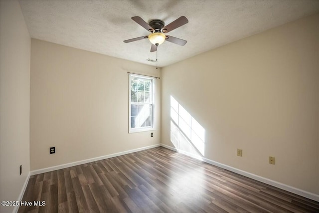 spare room featuring ceiling fan, dark hardwood / wood-style floors, and a textured ceiling