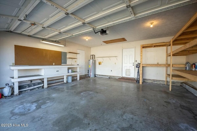 garage with a workshop area, a garage door opener, and water heater