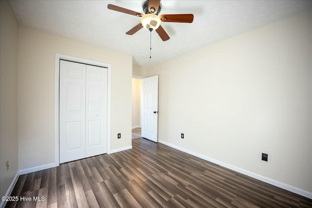 unfurnished bedroom with ceiling fan, dark hardwood / wood-style floors, and a closet