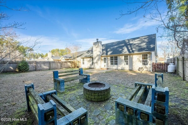 back of property featuring a patio area and a fire pit