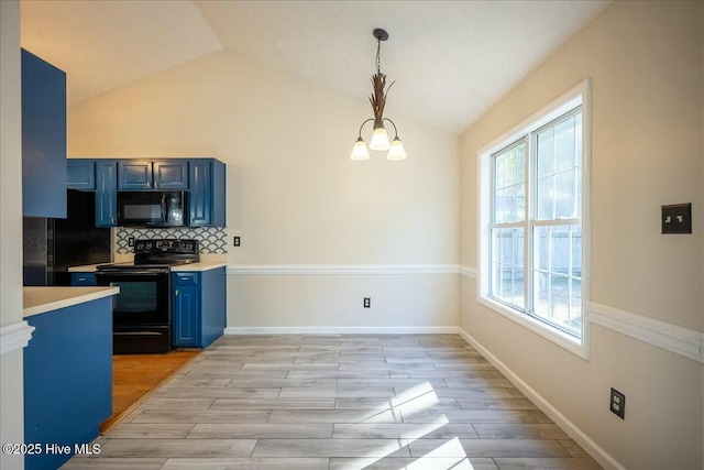 kitchen featuring pendant lighting, backsplash, black appliances, and blue cabinetry