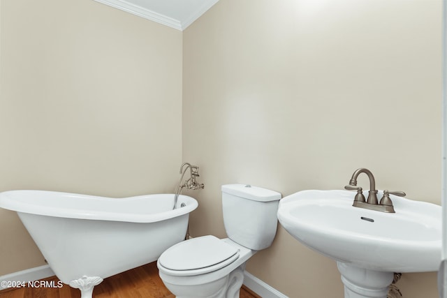 bathroom featuring toilet, sink, ornamental molding, a bathing tub, and hardwood / wood-style flooring