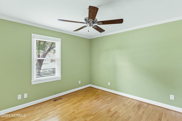 spare room with ornamental molding, ceiling fan, and light wood-type flooring