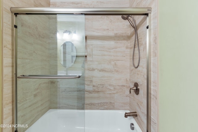 bathroom featuring shower / bath combination with glass door