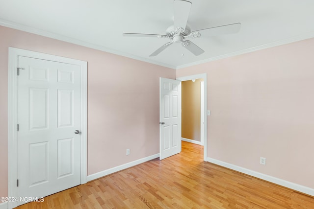 unfurnished bedroom with ceiling fan, ornamental molding, and light wood-type flooring