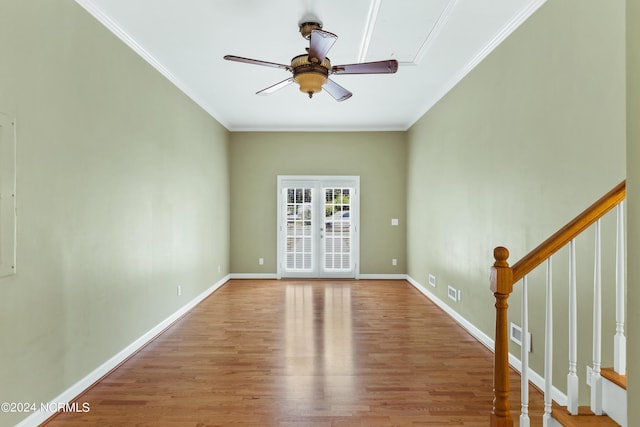 spare room featuring hardwood / wood-style flooring, ornamental molding, ceiling fan, and french doors