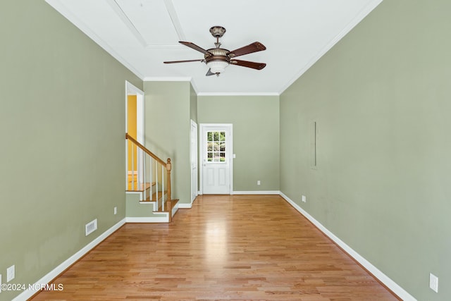 entryway with crown molding, ceiling fan, and light hardwood / wood-style flooring