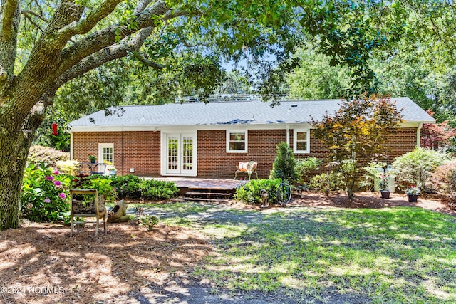 back of house featuring french doors, a yard, and a wooden deck