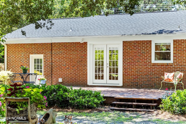 back of property with a deck and french doors