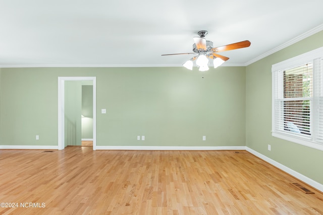 spare room with crown molding, light hardwood / wood-style flooring, and ceiling fan