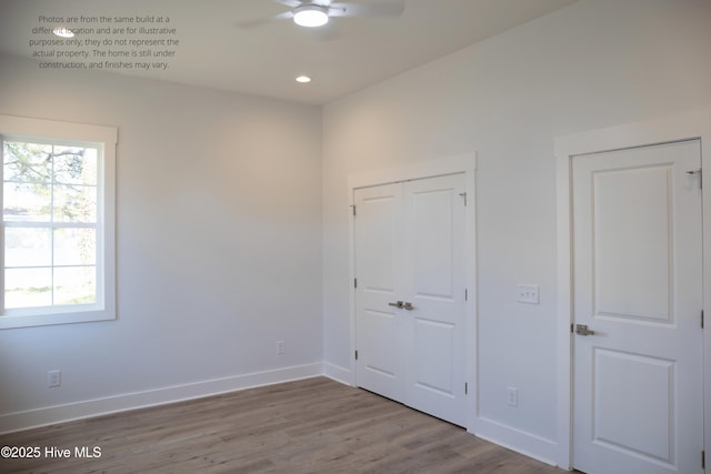 unfurnished bedroom featuring wood-type flooring, a closet, and ceiling fan